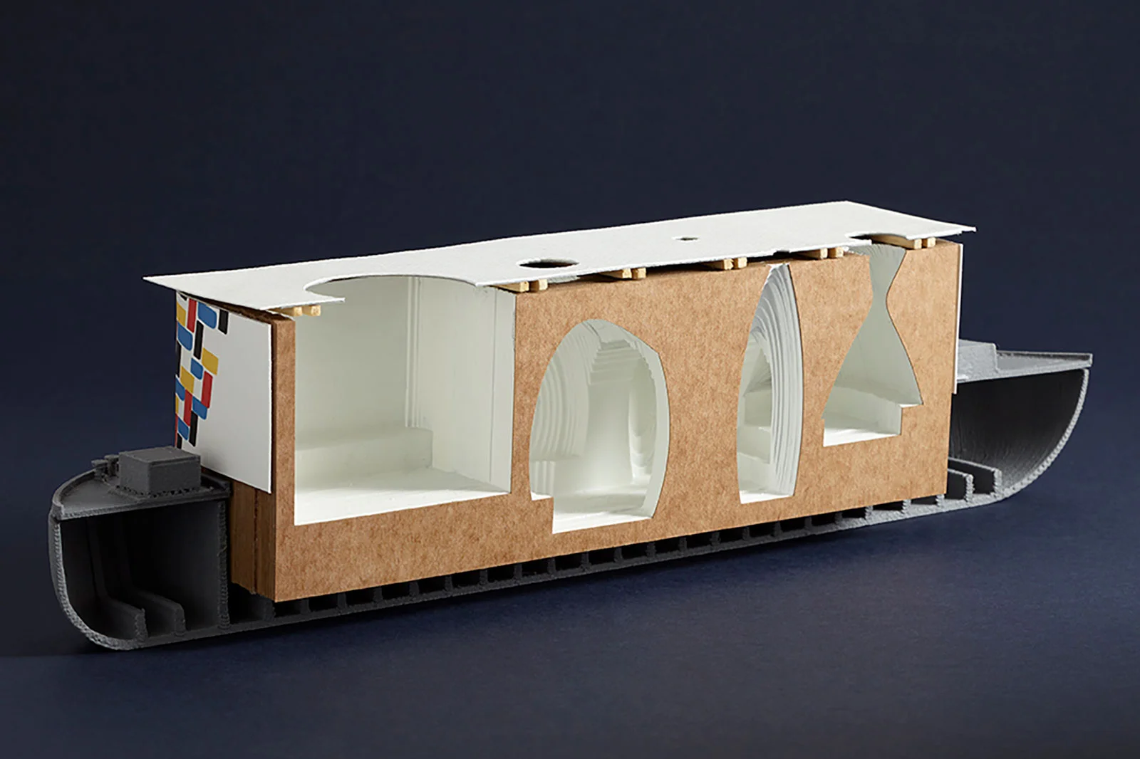 The design developed with a view towards keeping the construction process simple and costs at a low. An environmentally sustainable timber frame, in-filled with hay bales to form a large, well-insulated rectangular volume, that is then carved and sc