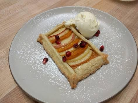 Apple and persimmon crostada with pomegranates and vanilla gelato