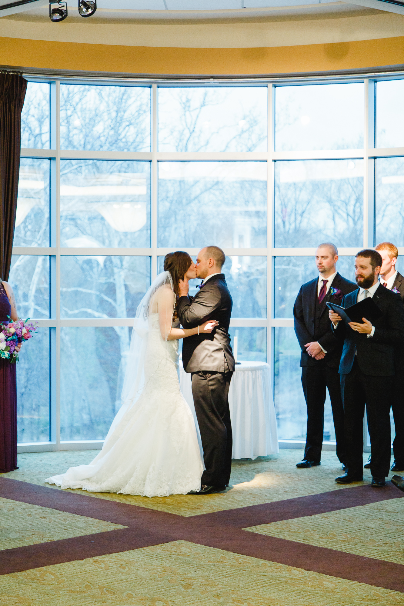 ceremony-first-kiss-a-ohio-lighting-ocf-columbus-wedding-couple-bridal-creekside-conference-indoor-roxanna-sue-photos-ohio-photography-1.jpg