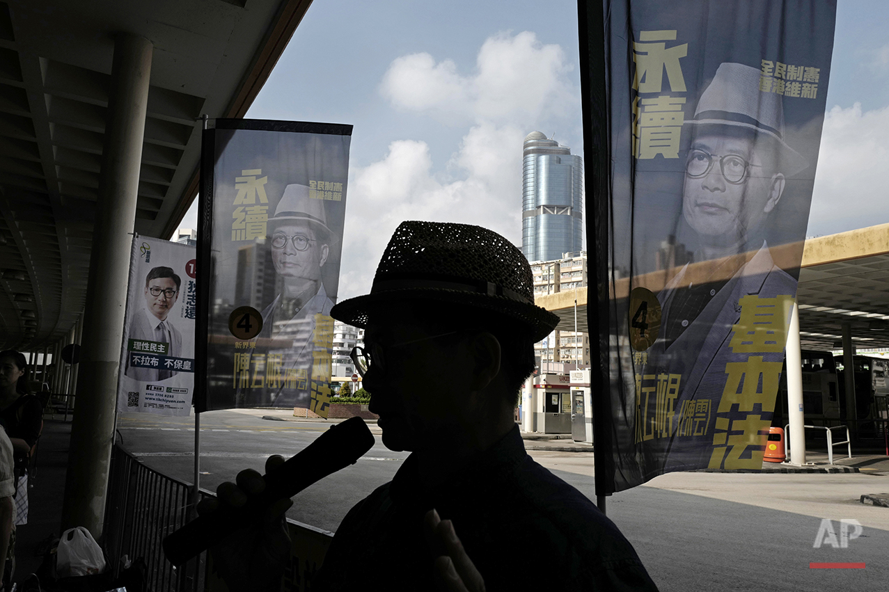  In this Aug. 25, 2016 photo, Horace Chin, a candidate in Hong Kong's upcoming legislative elections who's known as the "godfather of localism," is flanked by his campaign banners in Hong Kong. Hong Kongers head to the polls Sunday, Sept. 4, 2016 to 