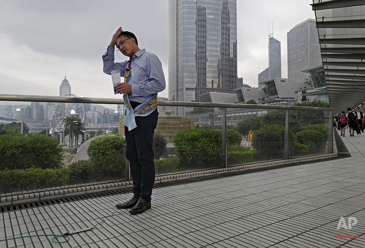  In this Aug. 29, 2016 photo, Junius Ho, a pro-Beijing candidate in Hong Kong's legislative election adjusts his hair during a campaigns for voters in Hong Kong. Hong Kongers head to the polls Sunday, Sept. 4, 2016 to choose candidates for the semiau