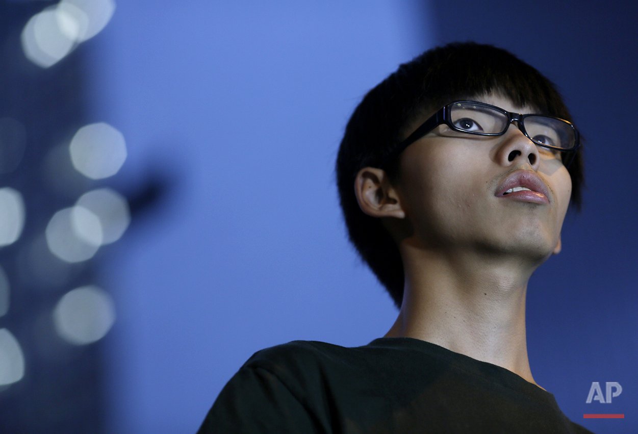  Joshua Wong, 17-year old student leader, stands on the stage during a rally in the occupied areas at Central district in Hong Kong, Thursday, Oct. 9, 2014. (AP Photo/Vincent Yu) 