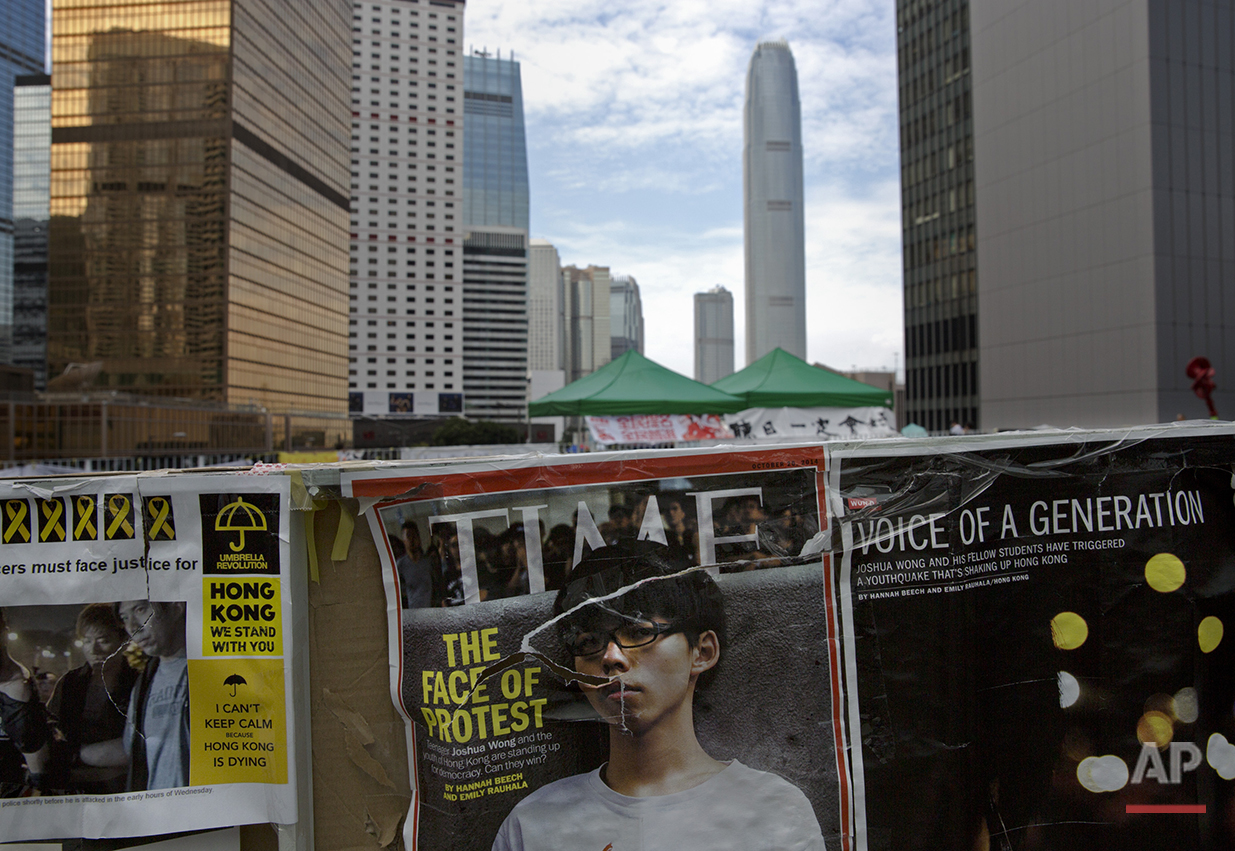  A Time magazine cover featuring Hong Kong's student Joshua Wong is seen at an occupied area by pro-democracy protesters outside the government headquarters in Hong Kong's Admiralty district, Tuesday, Oct. 21, 2014. (AP Photo/Vincent Yu) 