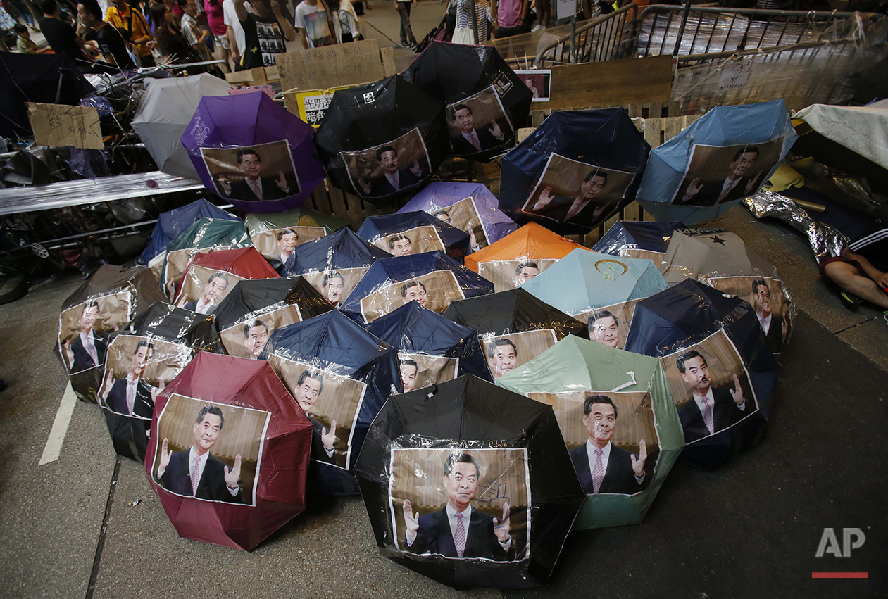  Iconic umbrellas used in the pro-democracy protests dubbed "The Umbrella Revolution" are used to display portraits of Hong Kong's embattled leader Leung Chun-ying in an occupied area in the Mong Kok district of Hong Kong, Saturday, Oct. 18, 2014. (A