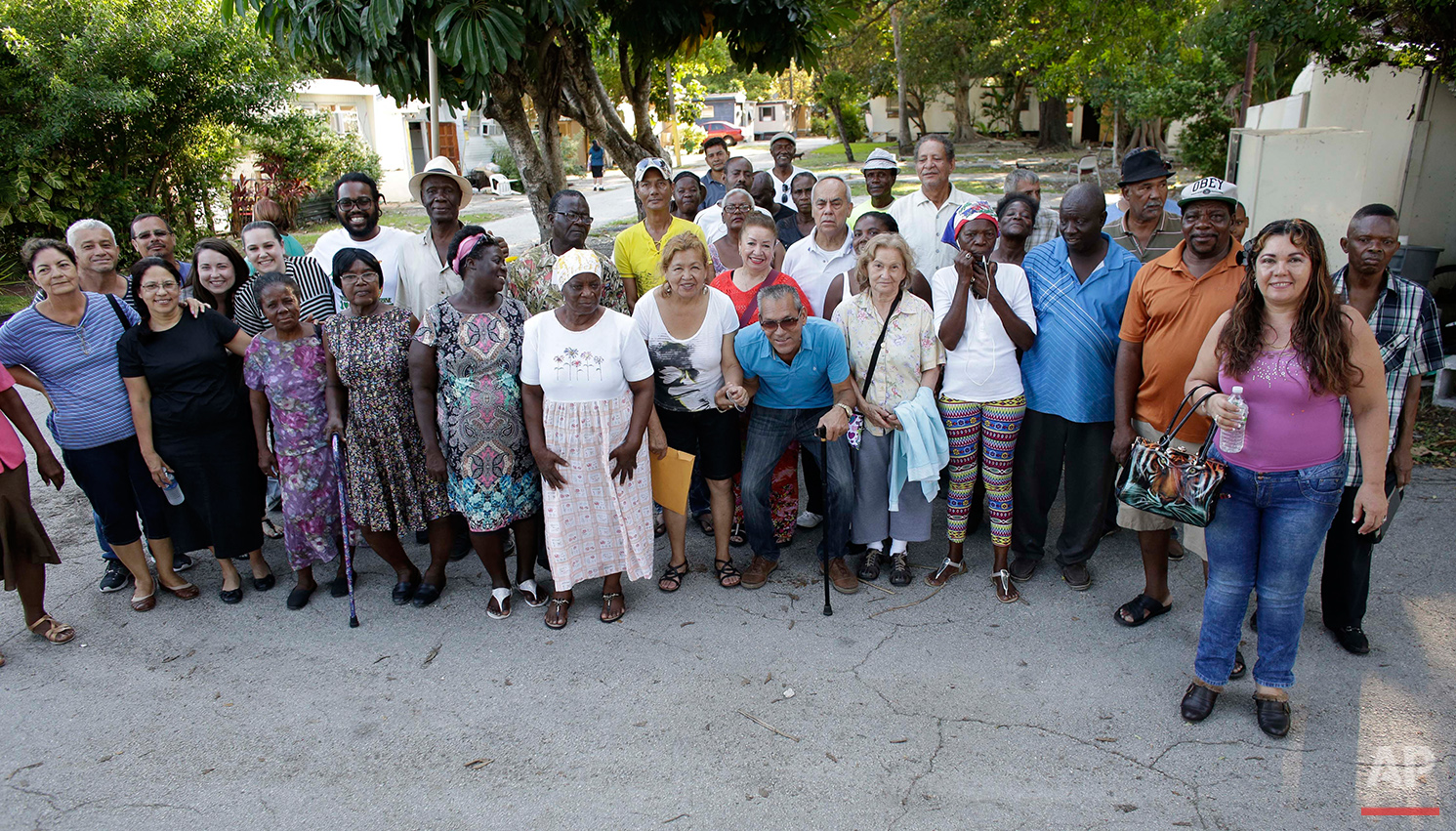  In this Tuesday, June 14, 2016 photo, residents of the Little Farm trailer park pose for a group photo in El Portal, Fla. The 15-acre neighborhood was home to a close-knit community until the site was purchased by Wealthy Delight LLC, and residents 