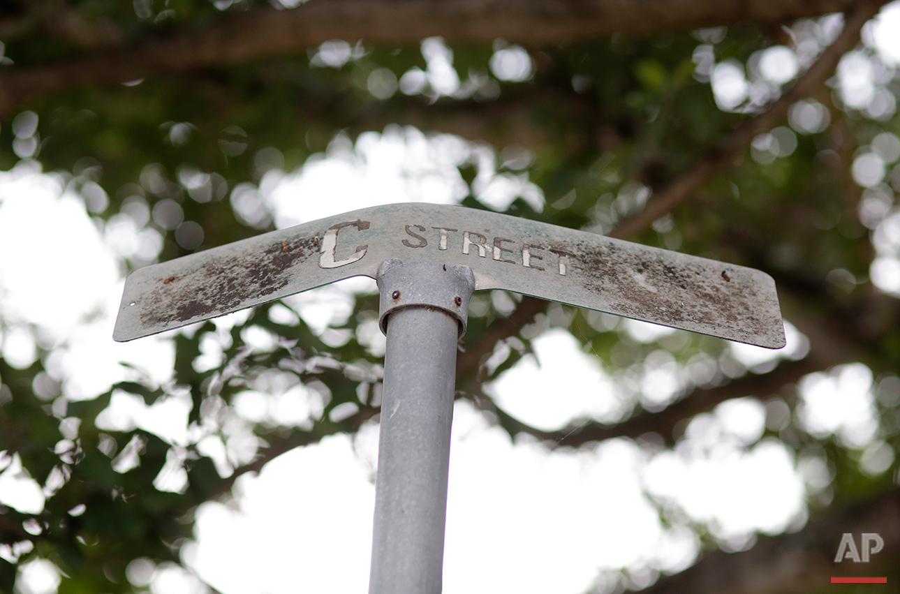  This Tuesday, July 12, 2016 photo shows a bent street sign at the Little Farm trailer park in El Portal, Fla. Residents, many of whom had owned their mobile homes in this close-knit community for years, were evicted in July after the park was purcha