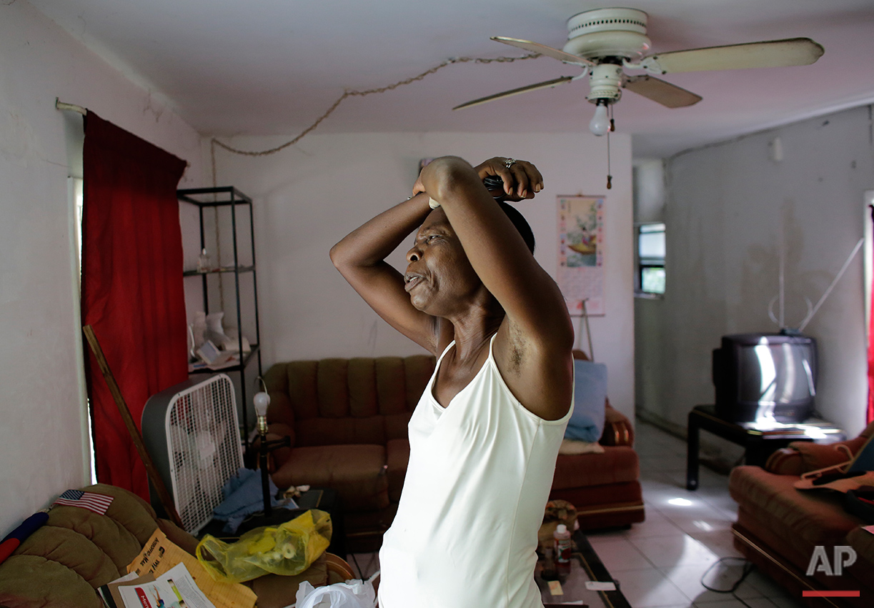  In this Saturday, July 30, 2016 photo, Clairmise Blanc, 72, reminiscences about her life as she packs her belongings to move from the Little Farm trailer park in El Portal, Fla. Blanc, who has lived in the trailer she owns for eight years, says it's