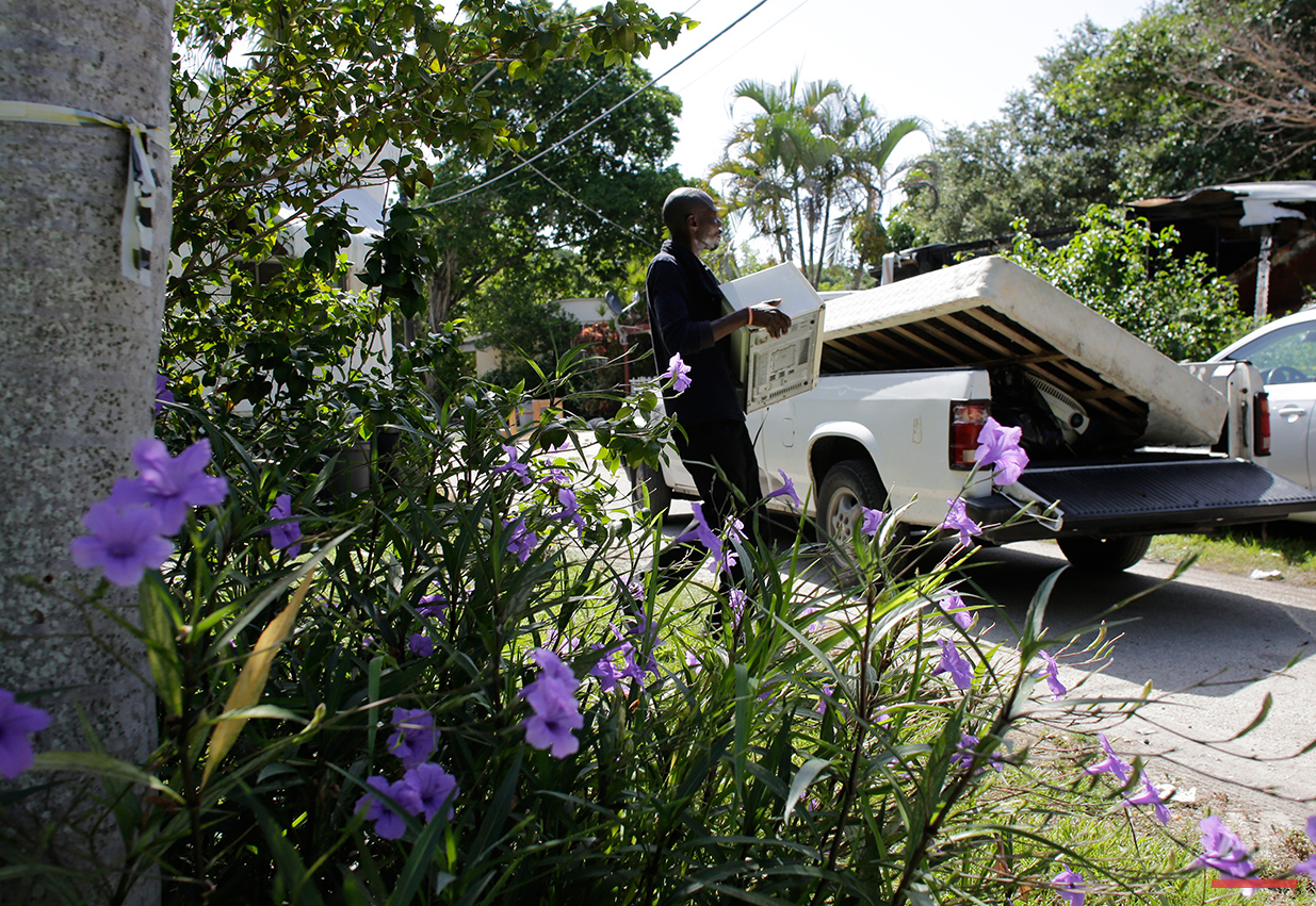  In this Saturday, July 30, 2016 photo, friends load a truck with the belongings of resident Clairmise Blanc at the Little Farm trailer park in El Portal, Fla. Blanc, who has lived in the trailer she owns for eight years, says it's important to fight