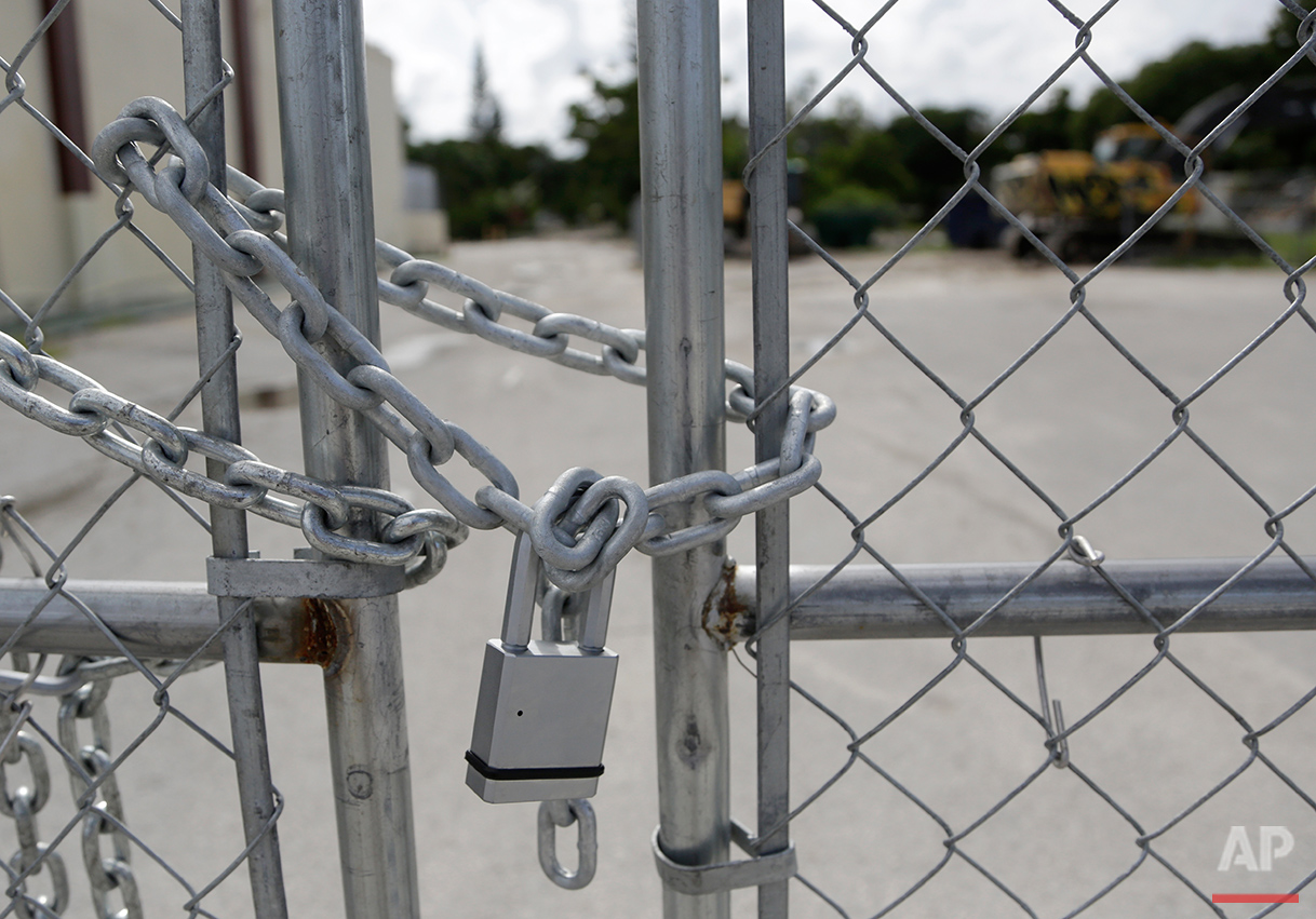  In this Monday, Aug. 29, 2016 photo, a padlock secures a fence blocking entry to the Little Farm trailer park in El Portal, Fla. Residents, many of whom had owned their mobile homes in this close-knit community for years, were evicted in July after 