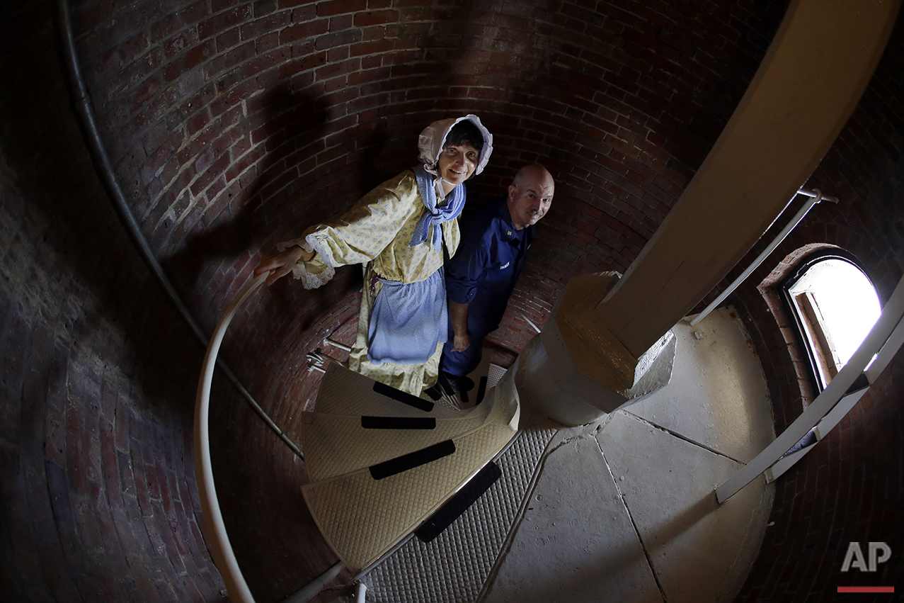  In this Aug. 17, 2016 photo, Sally Snowman, the keeper of Boston Light, and her husband, Jay Thomson of the Auxiliary Coast Guard, climb down the steps inside the lighthouse on Little Brewster Island in Boston Harbor. (AP Photo/Elise Amendola)&nbsp;