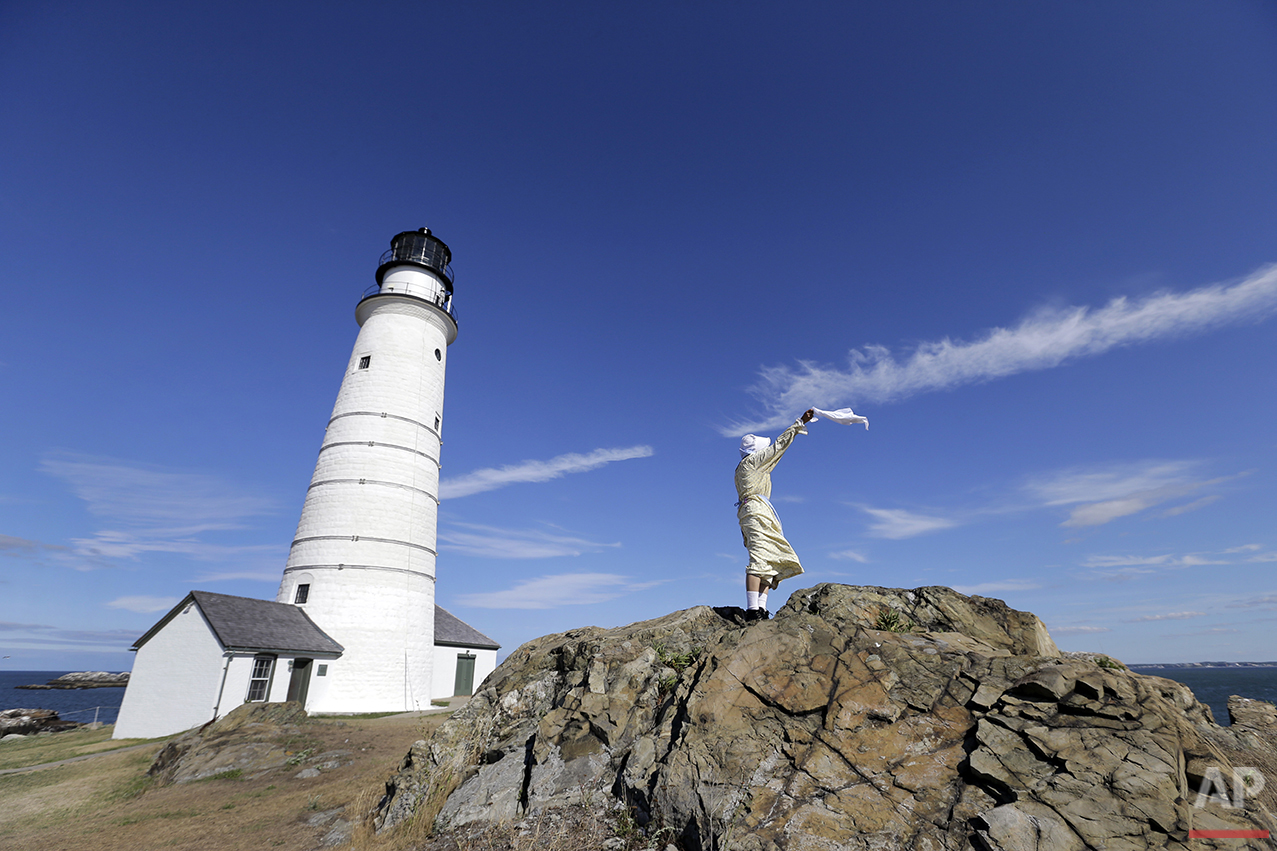  In this Aug. 17, 2016 photo, Sally Snowman, the keeper of Boston Light, waves a cloth from a rock outcrop on Little Brewster Island in Boston Harbor. (AP Photo/Elise Amendola)&nbsp;See these photos on  APImages.com  