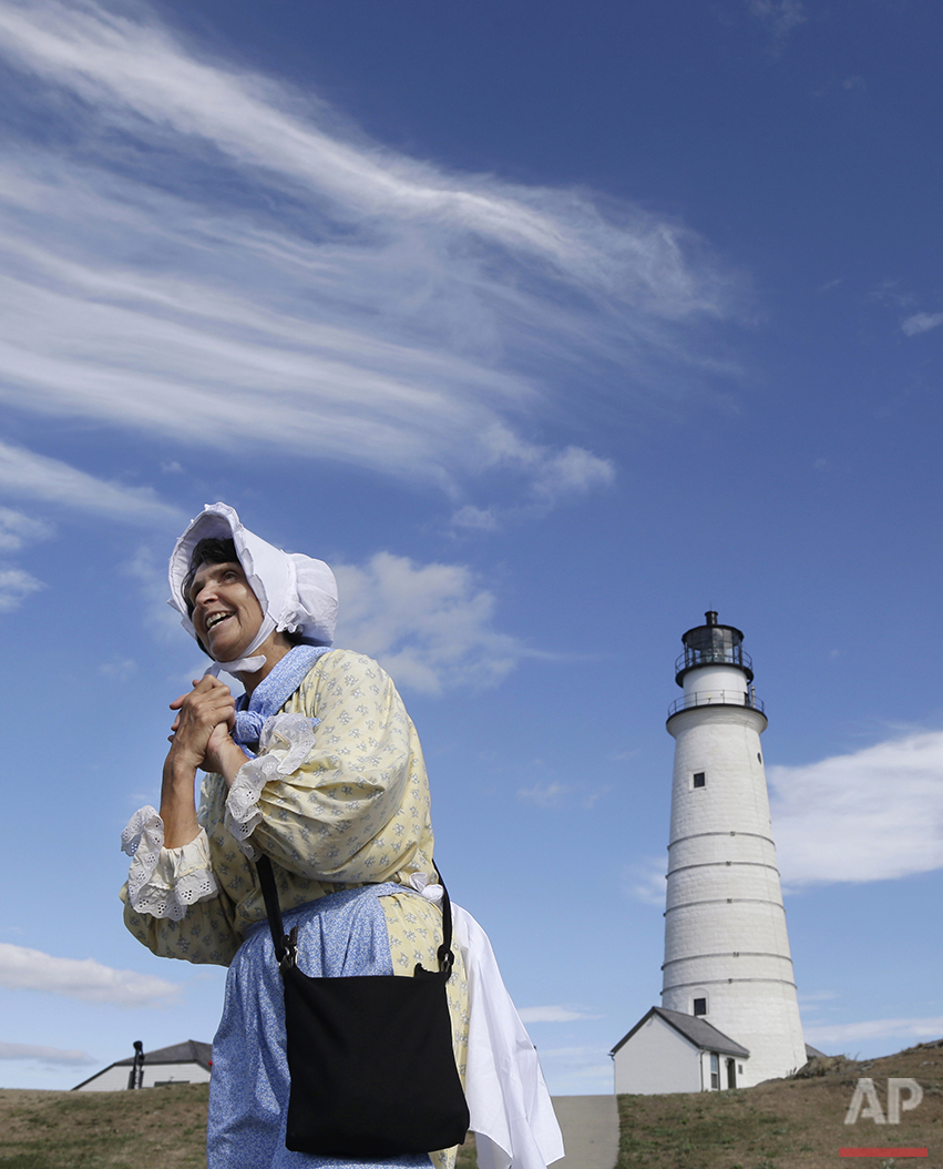  In this Aug. 17, 2016 photo, Sally Snowman, the keeper of Boston Light, wears Revolutionary-era clothing as she speaks about its history on Little Brewster Island in Boston Harbor. The U.S. Coast Guard's last manned station will celebrate the 300th 
