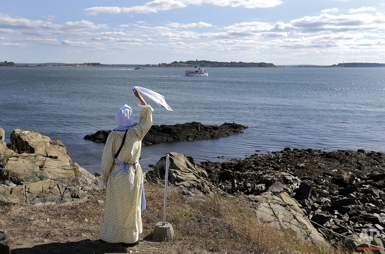  In this Aug. 17, 2016 photo, Sally Snowman, the keeper of Boston Light, waves to a cruise boat from Little Brewster Island in Boston Harbor. (AP Photo/Elise Amendola)&nbsp;See these photos on  APImages.com  