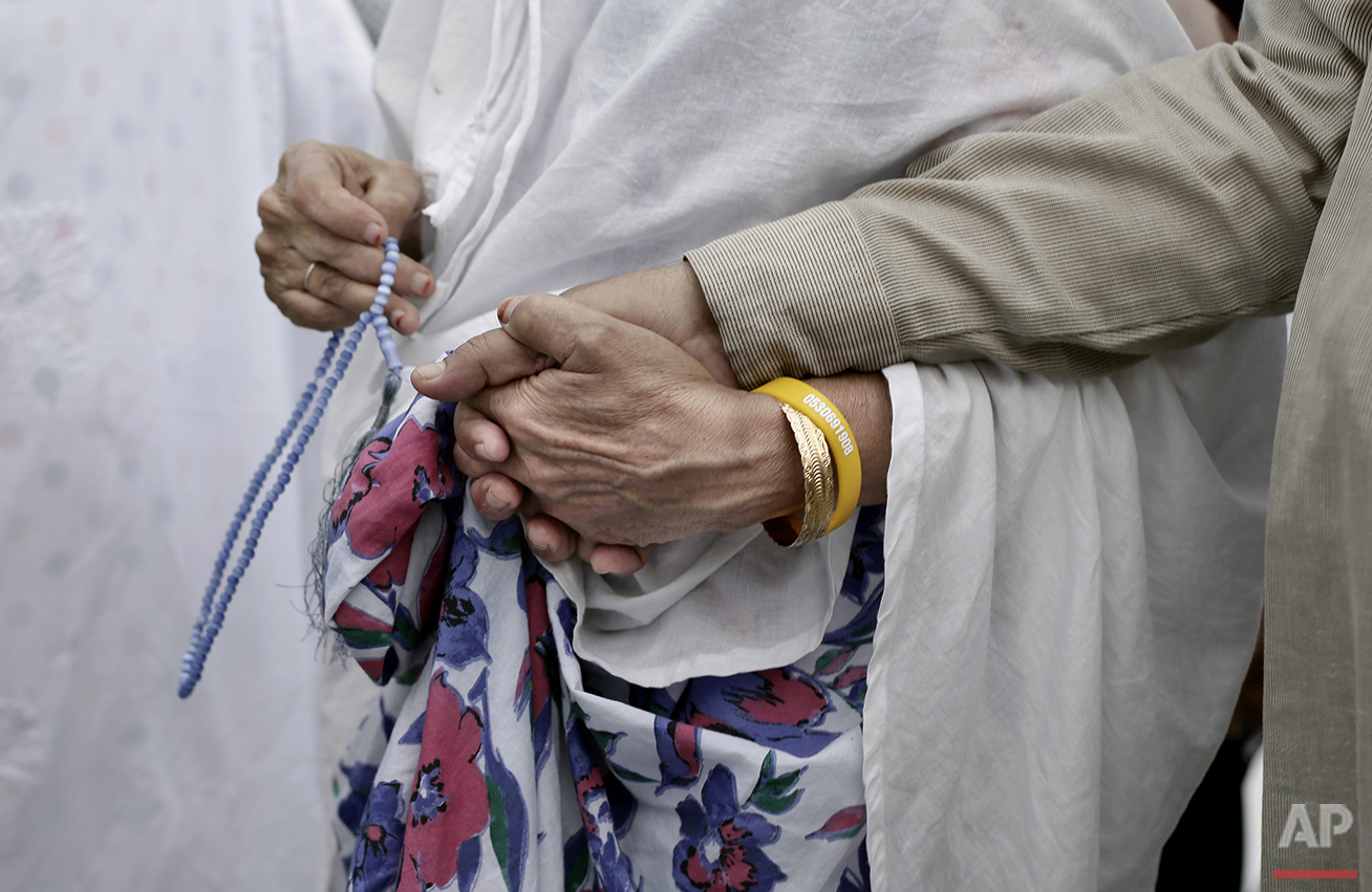  An Indian elderly woman leads her husband as they circle the Kaaba, Islam's holiest shrine, at the Grand Mosque in the Muslim holy city of Mecca, Saudi Arabia, Thursday, Sept. 8, 2016. Millions of pilgrims have arrived to Mecca ahead of the Hajj ann