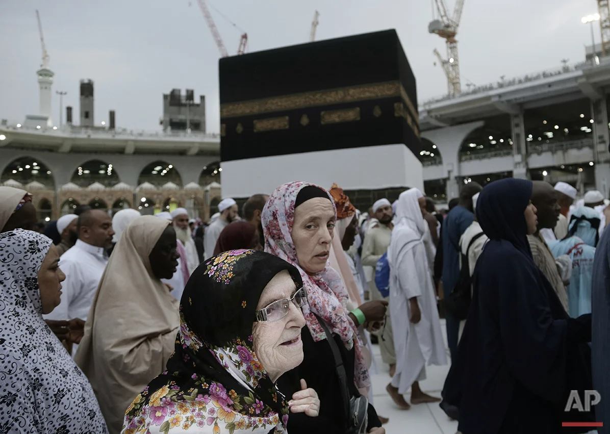  A woman holds her mother as they circle the Kaaba, Islam's holiest shrine, at the Grand Mosque in the Muslim holy city of Mecca, Saudi Arabia, Thursday, Sept. 8, 2016. Millions of pilgrims have arrived to Mecca ahead of the Hajj annual pilgrimage wh