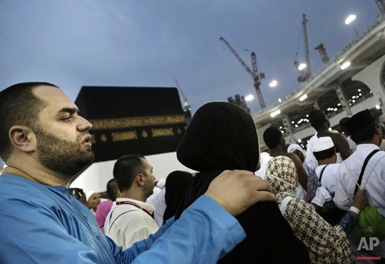  A man holds his wife as they circle the Kaaba, Islam's holiest shrine, at the Grand Mosque in the Muslim holy city of Mecca, Saudi Arabia, Thursday, Sept. 8, 2016. Millions of pilgrims have arrived to Mecca ahead of the Hajj annual pilgrimage which 