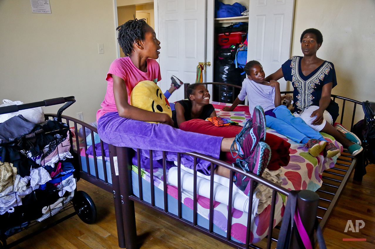  In this Wednesday, July 20, 2016 photo, Tonia Handy, far right, and her daughters, Rainn, 10, far left, Tai, 11, second from left, and Brooke, 8, second from right, together in the bedroom of their apartment in a Brooklyn shelter, in New York. "Some