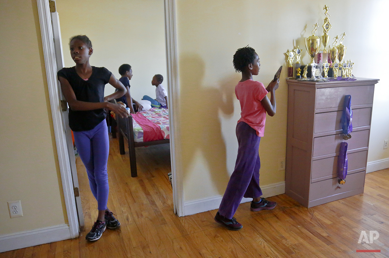  In this Wednesday, July 20, 2016 photo, Tonia Handy, second from left, chats with her youngest daughter Brooke Sheppard, 8, second from right, while older sisters Tai Sheppard, 11, far left, and Rainn Sheppard, 10, far right, stand out side the bedr