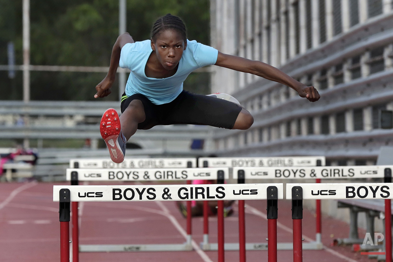  In this July 11, 2016 photo, Tai Sheppard, 11, practices hurdles at Boys and Girls High School, in the Brooklyn borough of New York. Every morning, Tai and her two young sisters wake up together with their mom in one bed in a Brooklyn homeless shelt