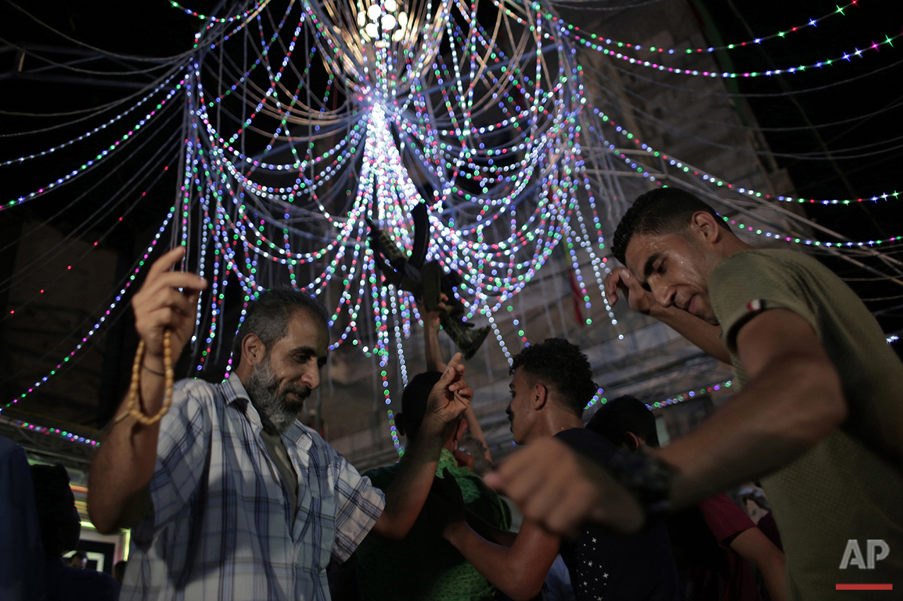  In this Thursday, July 29, 2016 photo, relatives of Palestinian groom Saed Abu Aser dance in a party celebrating his wedding in Gaza City. (AP Photo/ Khalil Hamra) 