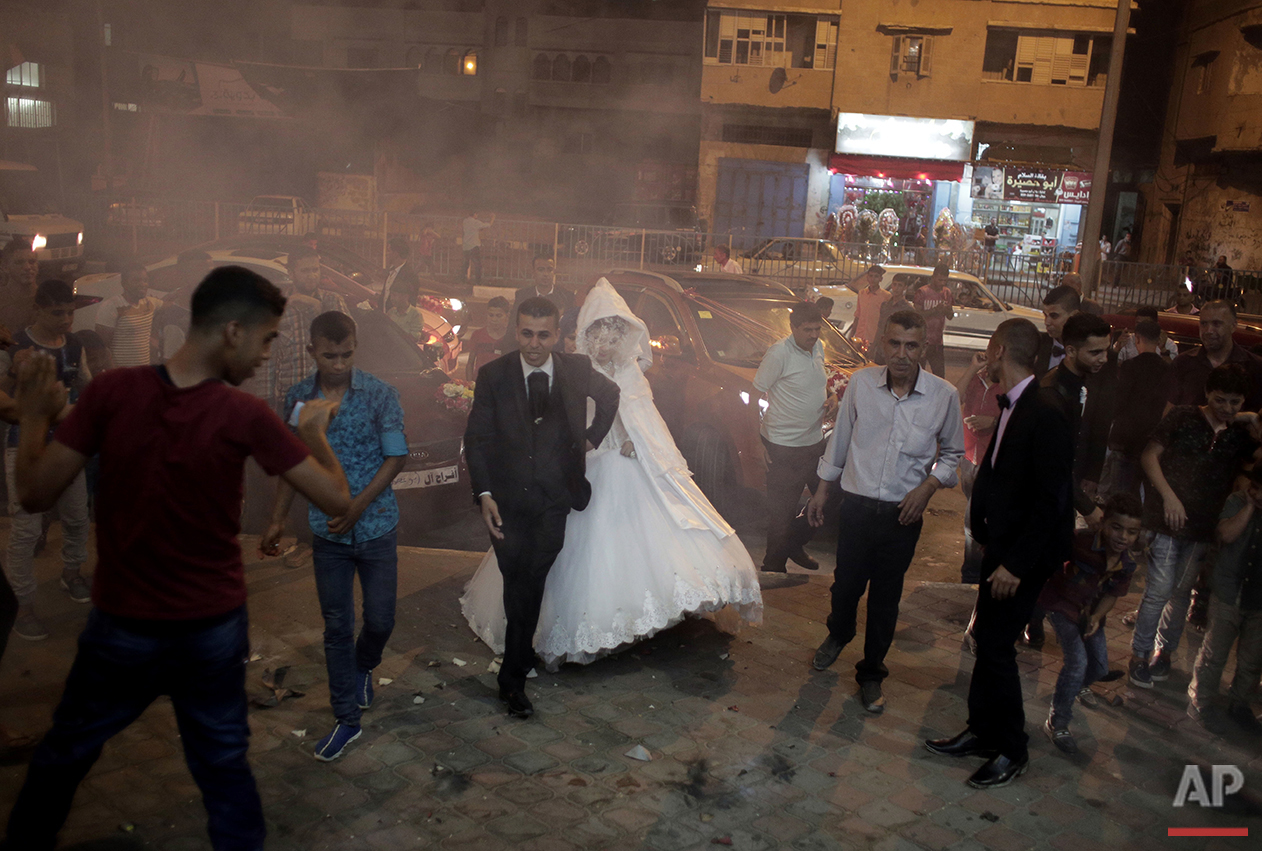  In this Saturday, July 31, 2016 photo, Palestinian groom Saed Abu Aser and his bride, Falasteen, walk into the wedding hall in Gaza City. (AP Photo/Khalil Hamra) 