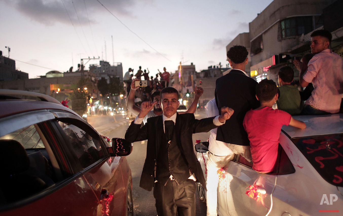  In this Saturday, July 31, 2016 photo, Palestinian groom Saed Abu Asers dances in the street on his way to the wedding hall in Gaza City. (AP Photo/Khalil Hamra) 