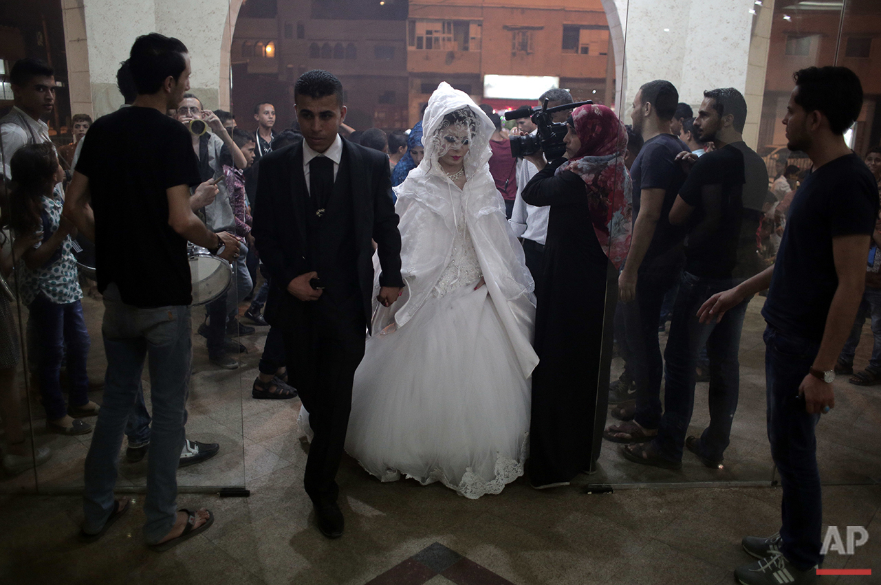 In this Saturday, July 30, 2016 photo, Palestinian groom Saed Abu Aser and his bride, Falasteen, walk into the wedding hall, in Gaza City. (AP Photo/ Khalil Hamra) 