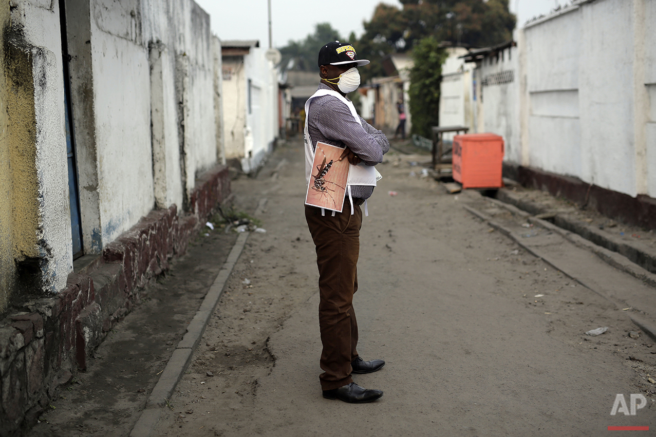  A member of a Doctors Without Borders (MSF) team holds a photo of a mosquito during fumigation efforts in the Yolo Sud neighborhood of Kinshasa, Congo, on Friday, July 22, 2016. The yellow fever virus is transmitted by the Aedes aegypti mosquito and