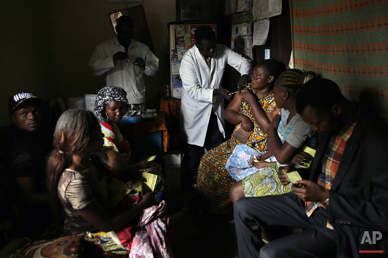  In this photo taken Thursday July 21, 2016, residents of the Kisenso district of Kinshasa, receive yellow fever vaccines. (AP Photo/Jerome Delay) 