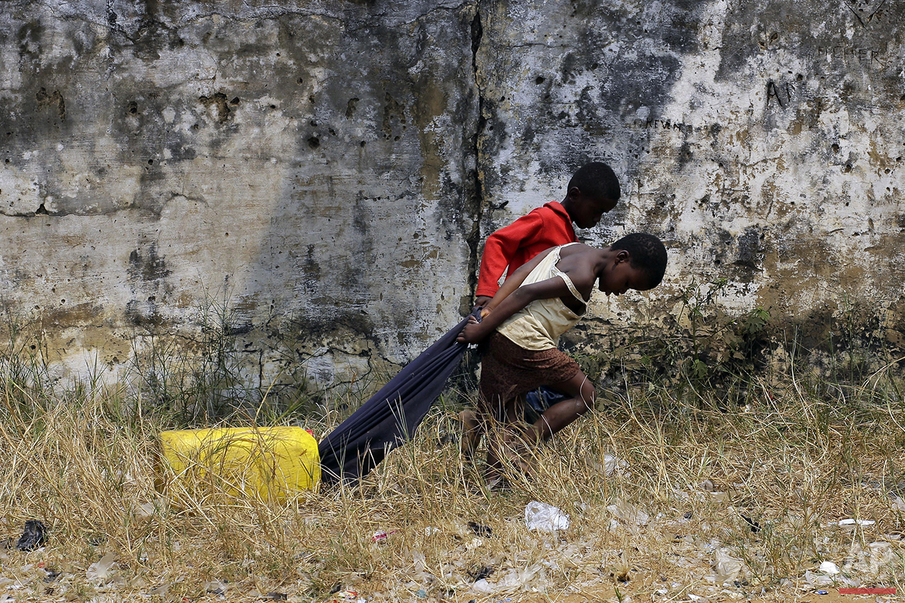  In this photo taken Wednesday July 20, 2016, children pull water in the Kisenso district of Kinshasa, Democratic Republic of Congo. (AP Photo/Jerome Delay) 