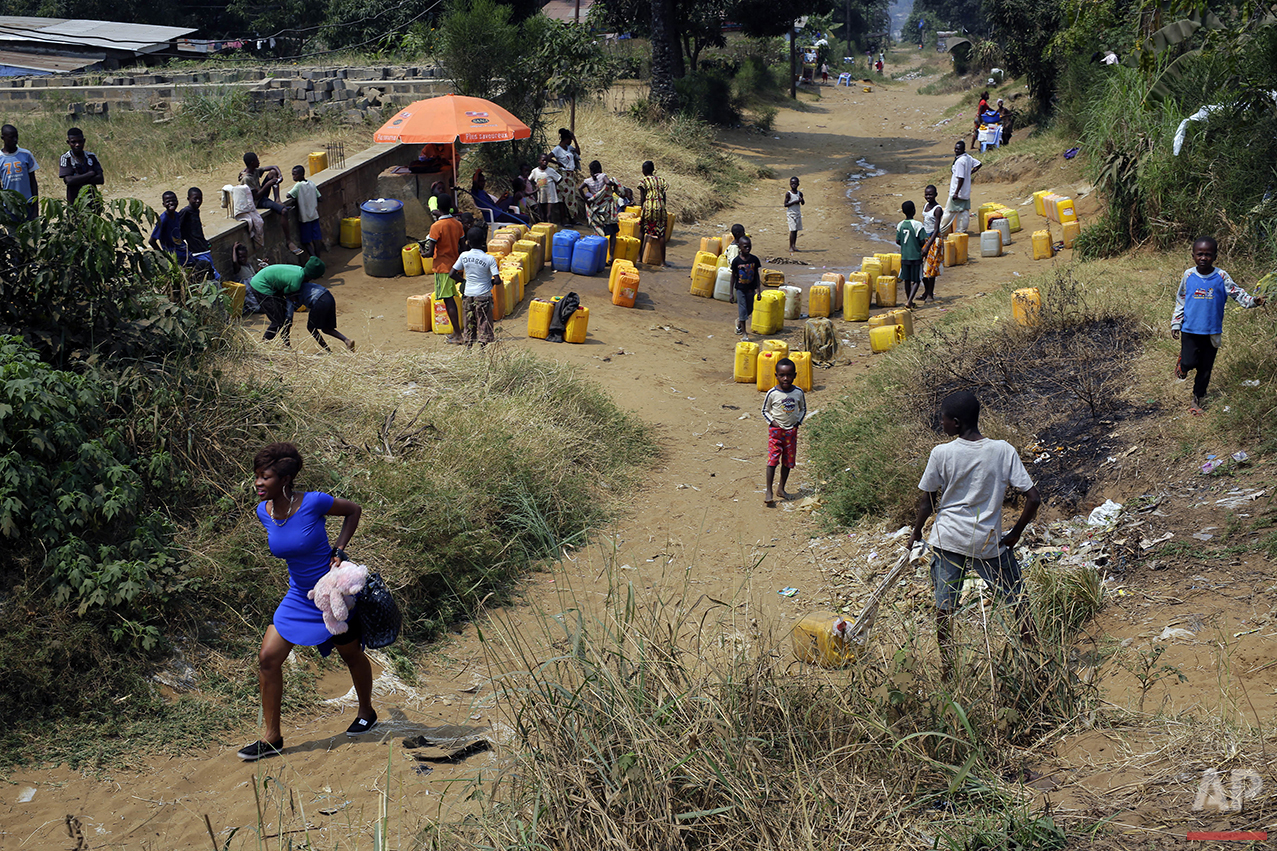  In this photo taken Wednesday July 20, 2016, residents of the Kisenso district of Kinshasa, Democratic Republic of Congo, gather at a water distribution point. (AP Photo/Jerome Delay) 