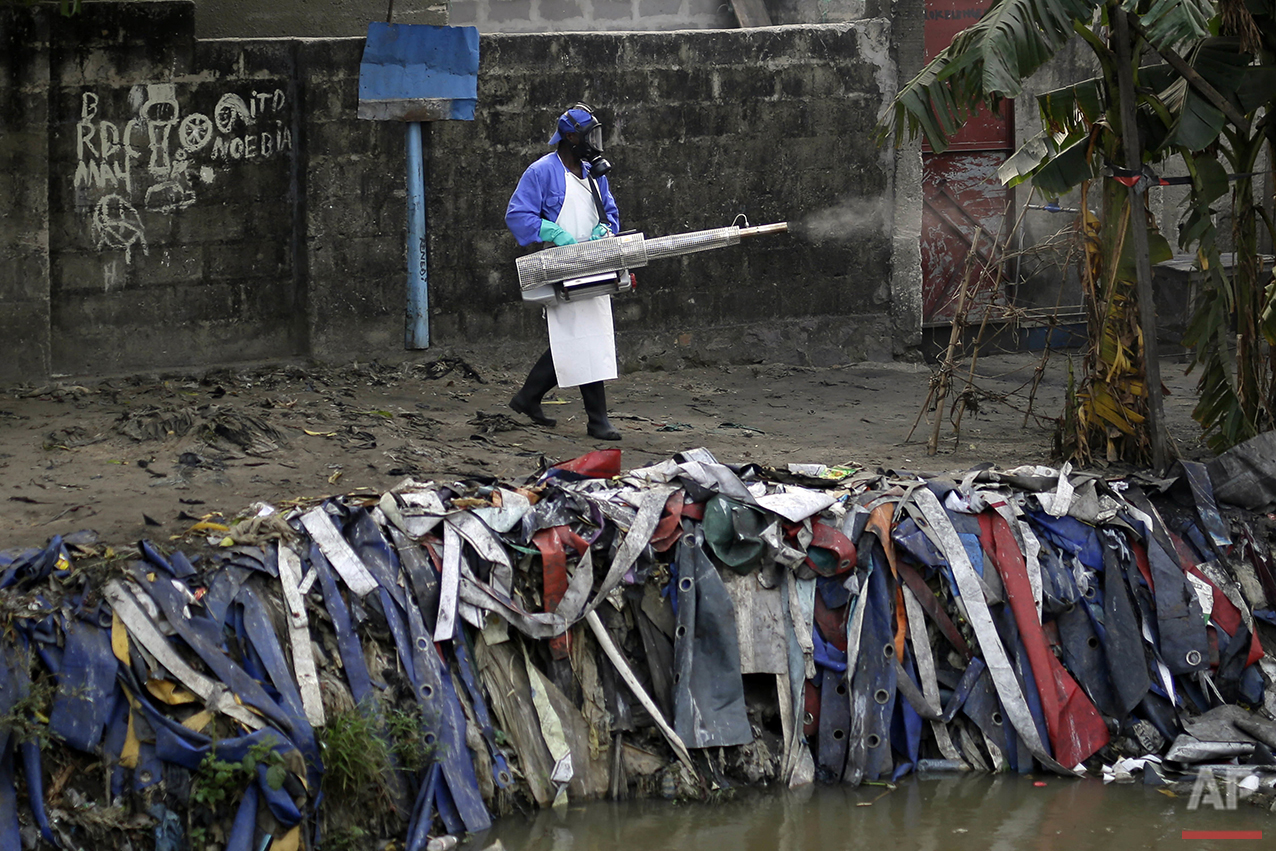  In this photo taken Friday July 22, 2016, teams from MSF carry out fumigation efforts in a bid to kill the mosquitos that transmit yellow fever. (AP Photo/Jerome Delay) 