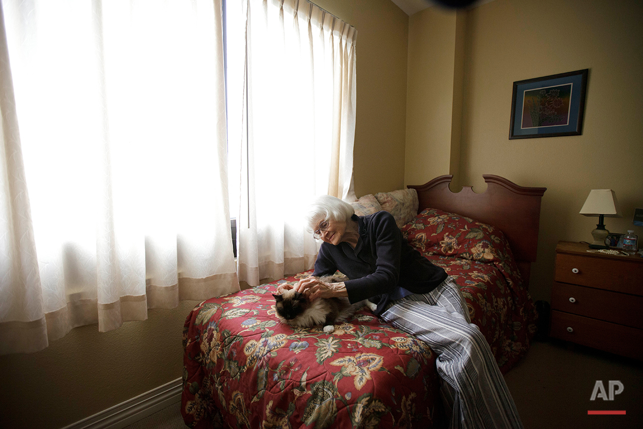  Joyce Kavanagh pets her cat as she sits in her room at the Silverado Senior Living Center Tuesday, May 1, 2012, in Encinitas, Calif. At the senior center, residents are encouraged to bring their pets. Everything from miniature horses to chinchillas 