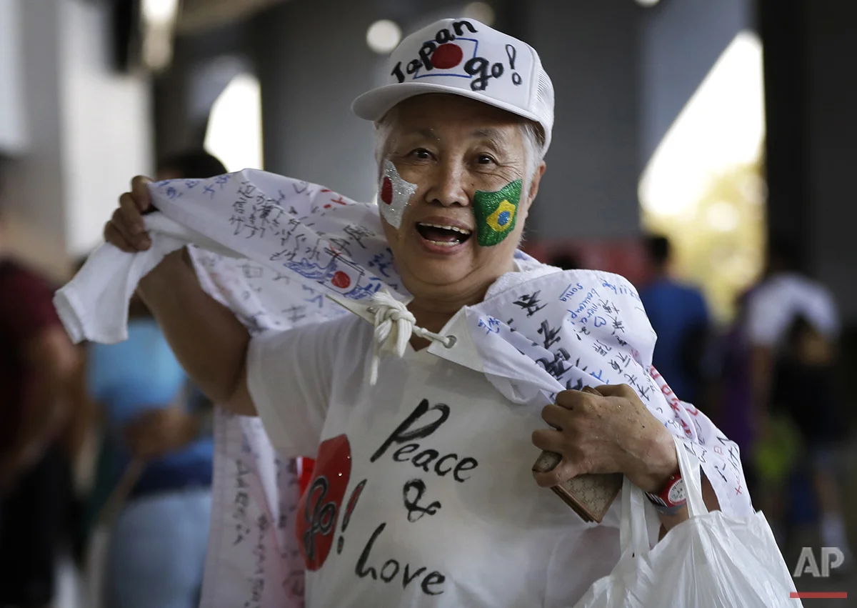 A Japanese fan arrives in a festive mood at the opening ceremony with flags of Japan and Brazil painted on her face at the 2016 Summer Olympics in Rio de Janeiro, Brazil, Friday, Aug. 5, 2016. (AP Photo/Robert F. Bukaty)
