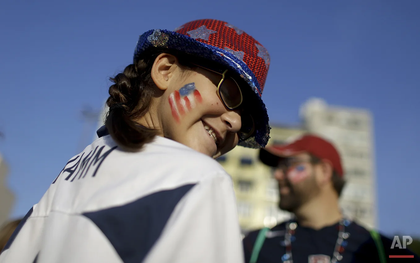 A fan from the United States smiles as she walks towards the Maracana Stadium ahead of the opening ceremony for the 2016 Summer Olympics in Rio de Janeiro, Brazil, Friday, Aug. 5, 2016. (AP Photo/Natacha Pisarenko)