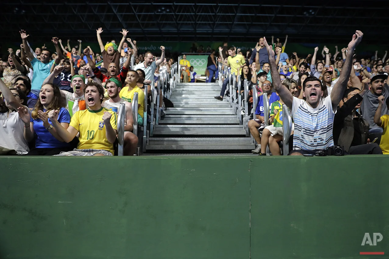 Brazilian fans cheer as they watch Hugo Calderano's table tennis match against Jun Mizutani, of Japan, at the 2016 Summer Olympics in Rio de Janeiro, Brazil, Monday, Aug. 8, 2016. (AP Photo/Jae C. Hong)