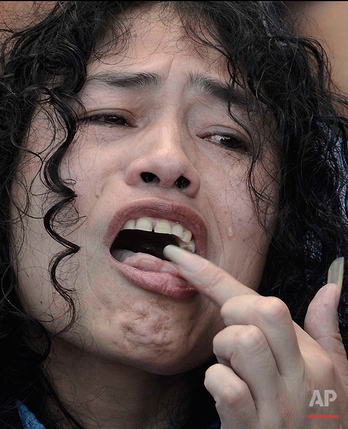  Indian political activist Irom Sharmila licks honey from her hand to break her fast in Imphal, north-eastern Indian state of Manipur, India, Tuesday, Aug. 9, 2016. One of India's most prominent political activists ended a 16-year hunger strike Tuesd