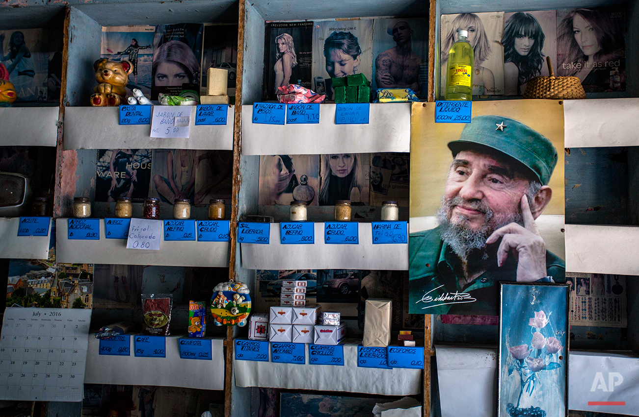  In this July 23, 2016 photo, a picture of Cuban Revolution leader Fidel Castro is placed on the shelves of a state rationing store or "bodega," ahead of his upcoming 90th birthday in Havana, Cuba. During 47 years in power, Fidel was a constant prese