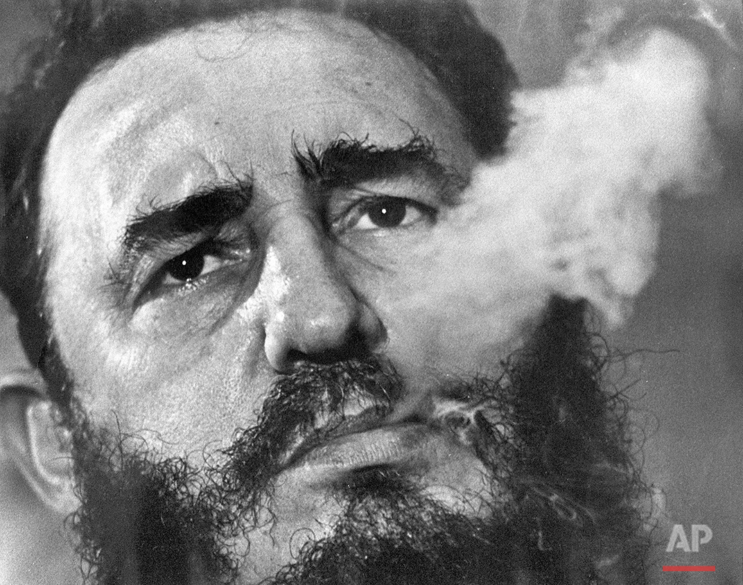  In this March 1985 photo, Cuban Prime Minister Fidel Castro exhales cigar smoke during an interview at his presidential palace in Havana, Cuba. Castro, a Havana attorney who fought for the poor, overthrew dictator Fulgencio Batista's government on J
