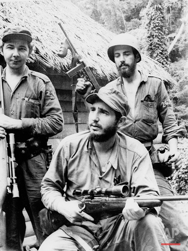  In this March 14, 1957 photo, Fidel Castro, the young anti-Batista guerrilla leader, center, is seen with his brother Raul Castro, left, and Camilo Cienfuegos, right, while operating in the Mountains of Eastern Cuba. The man who nationalized the Cub