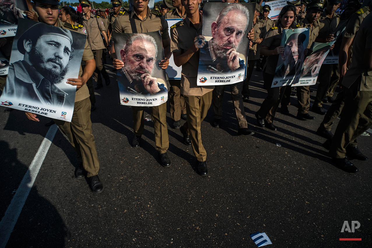  In this May 1, 2016 photo, soldiers with images of Cuban leader Fidel Castro march during the May Day parade at Revolution Square, in Havana, Cuba. Thousands of people converged on the square for the traditional May Day march. Fidel Castro will turn