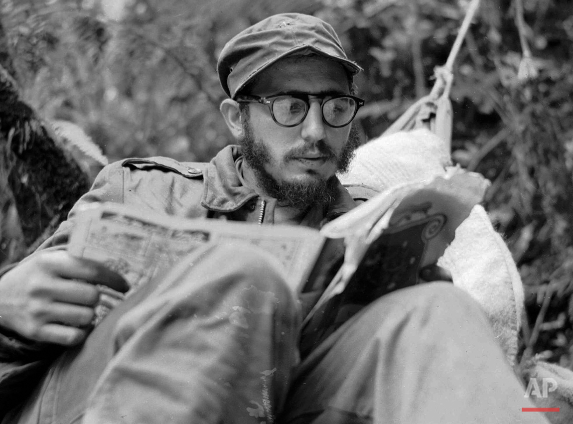  Cuban guerrilla leader Fidel Castro does some reading while at his rebel base in Cuba's Sierra Maestra mountains in this 1957 photo. (AP Photo/Andrew St. George) 