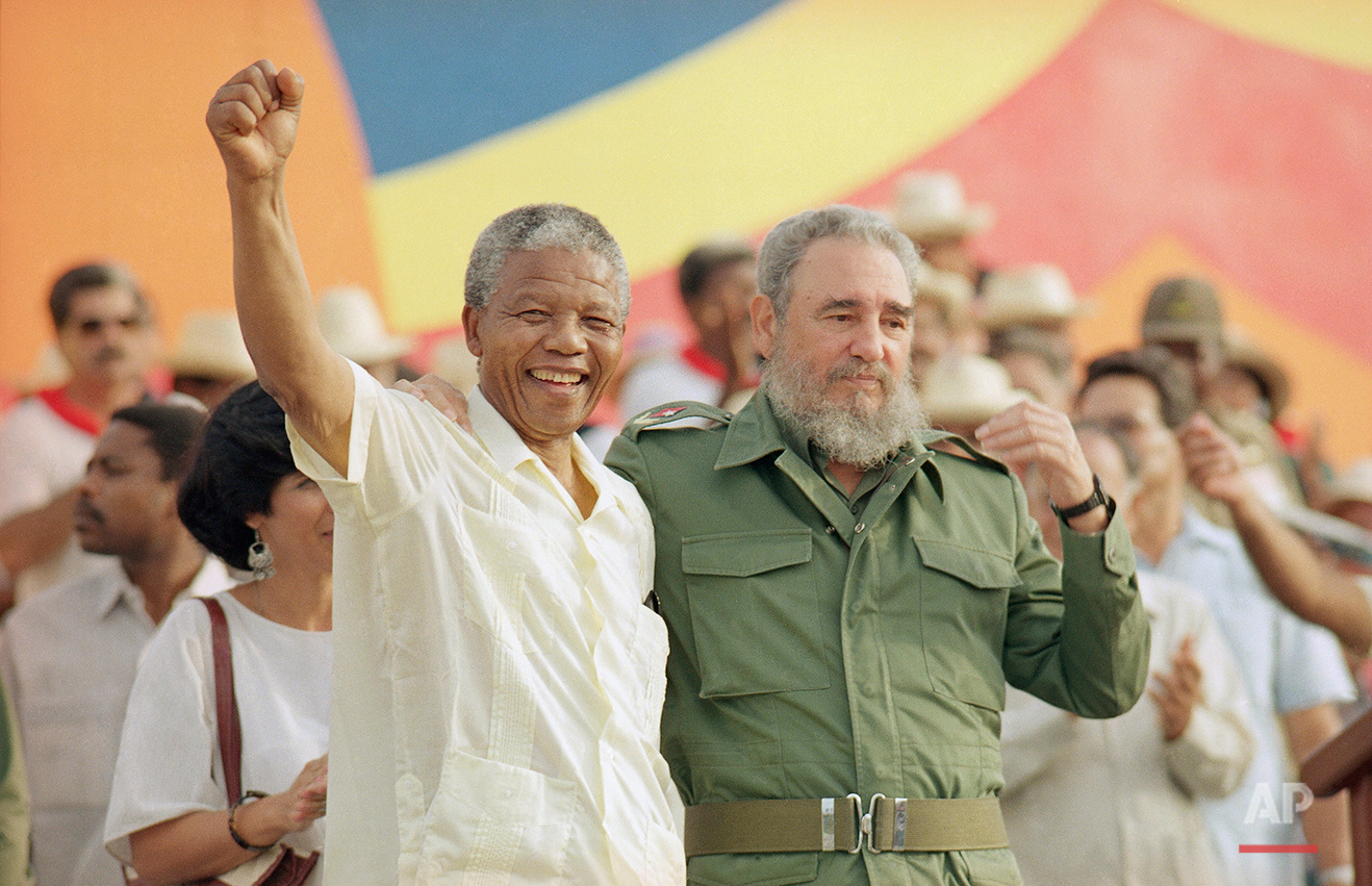  Cuban President Fidel Castro, right, and African leader Nelson Mandela gesture during the celebration of the "Day of the Revolution" in Matanzas Saturday, July 27, 1991. (AP Photo) 