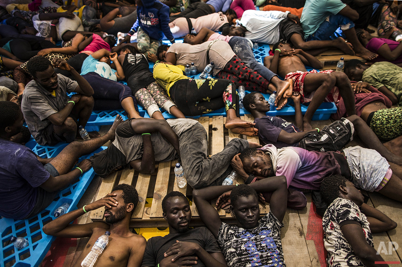 Migrants from Nigeria and the Ivory Coast rest on a vessel after being rescued by a Migrant Offshore Aid Station (MOAS) team in the central Mediterranean Sea, close to the Libyan territorial waters on Wednesday, Aug. 10, 2016. (AP Photo/Manu Brabo)