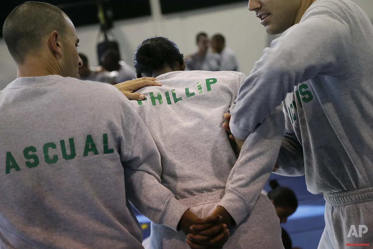 In this Friday, July 29, 2016 photo, Los Angeles County sheriff's deputy recruit Renata Phillip, center, trains with David Pascual, left, and Robert Nichols during a defensive tactics class at the Biscailuz Regional Training Center in Monterey Park,