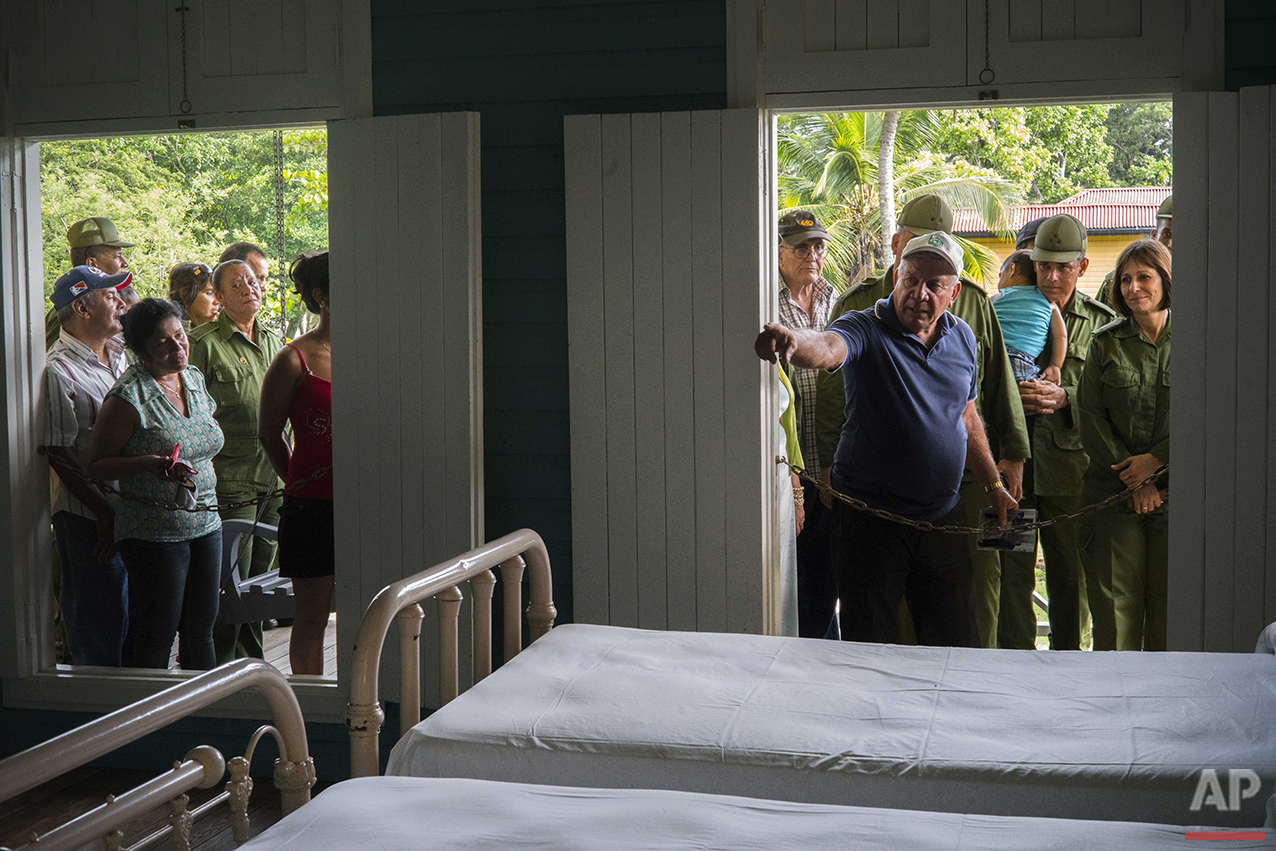  In this June 10, 2016 photo, a guide shows tourists and visiting soldiers the bedroom that was shared by Fidel Castro and his brothers at the home-turned-museum where the Castro brothers grew up in Biran, Cuba. Museum director Lazaro Castro, no rela