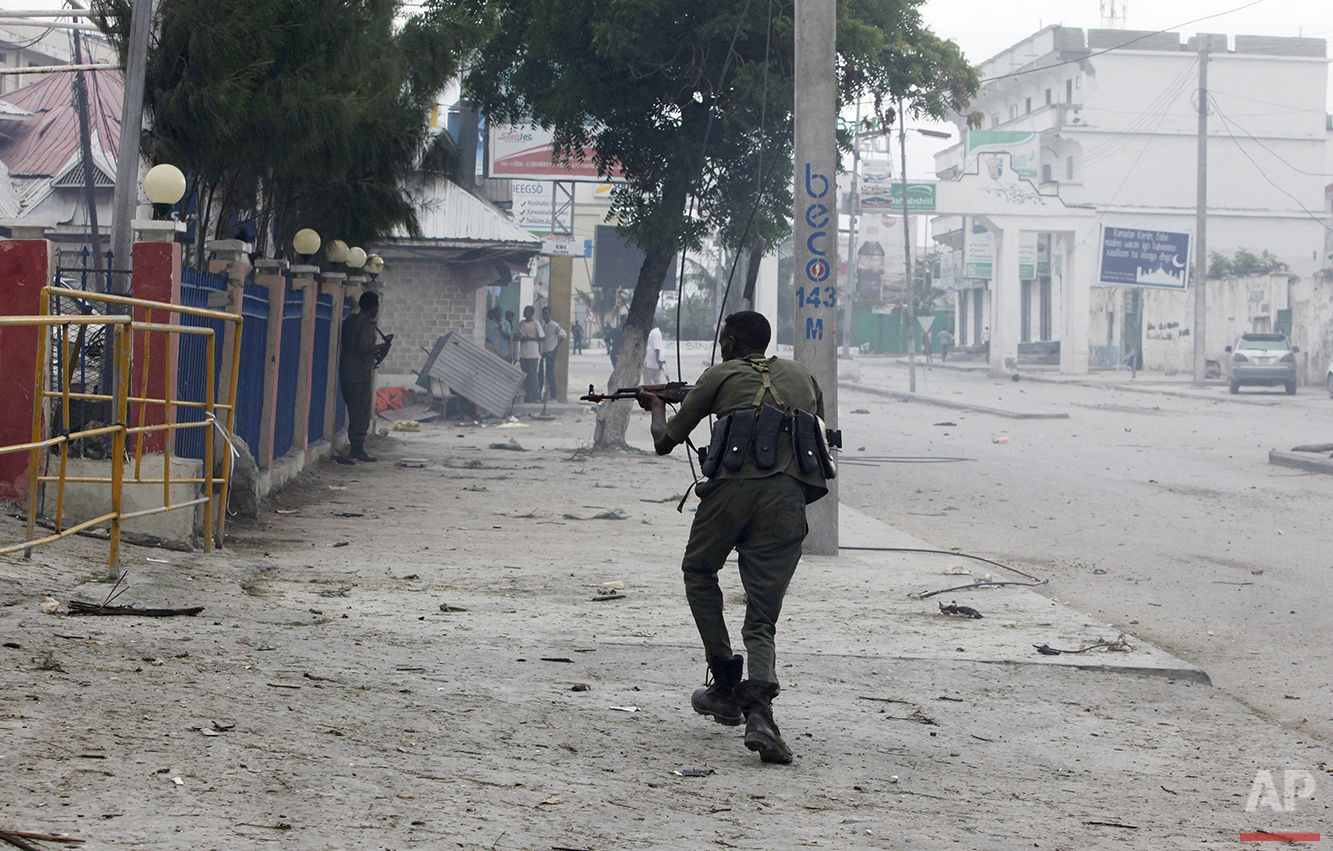 A Somali soldier takes position during an attack on the Nasahablod Hotel in Mogadishu, Somalia on Saturday, June 25, 2016. Gunmen stormed the hotel, taking guests hostage and "shooting at everyone they could see," before security forces pursued the grenade-throwing assailants to the top floor and ended the hours-long deadly assault, police and witnesses said. (AP Photo/Farah Abdi Warsameh)