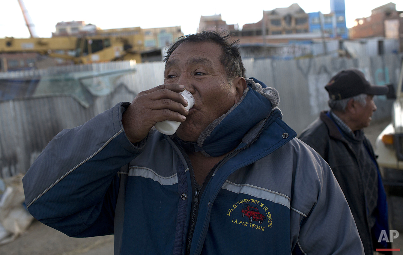  In this June 8, 2016 photo, bus driver Luis Lari Huanca drinks a glass of donkey milk in El Alto, Bolivia. “My fellow drivers advised me to drink donkey milk because I suffer lung and kidney pain,” Lari Huanca said. “It’s the third day. I hope it cu