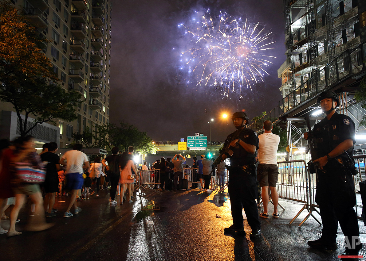  Counterterrorism police officers watch over spectators for the Fourth of July fireworks along the East River in New York on Monday, July 4, 2016. (AP Photo/Adam Hunger) 