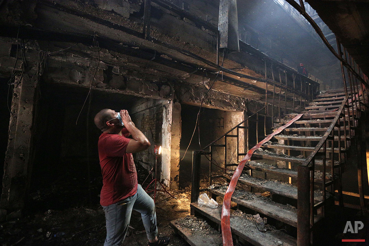  A man looks for victims at the site of a car bomb at a commercial area in the Karada neighborhood of Baghdad, Sunday, July 3, 2016. Hundreds were killed in two separate bomb attacks in and around the capital. The Islamic State group has claimed resp